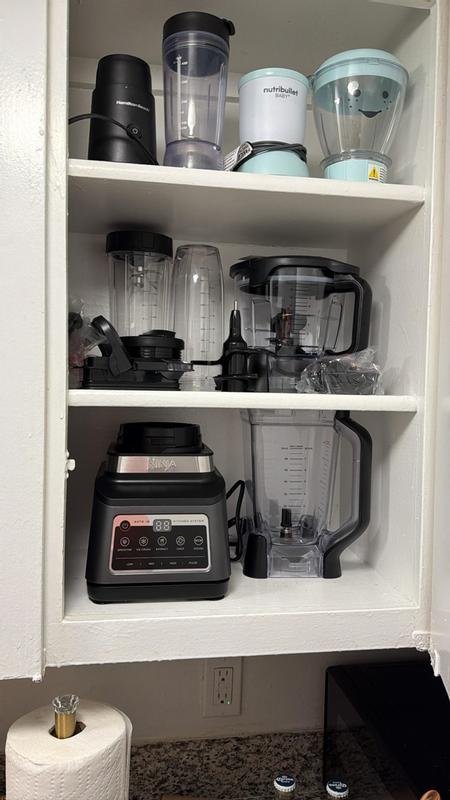 Ninja Kitchen System in the kitchen cupboard next to older appliances